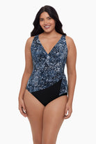 Woman wearing one-piece swimsuit with a paisley-esque pattern 
