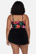 Woman turned away wearing a pink and orange floral printed swim dress