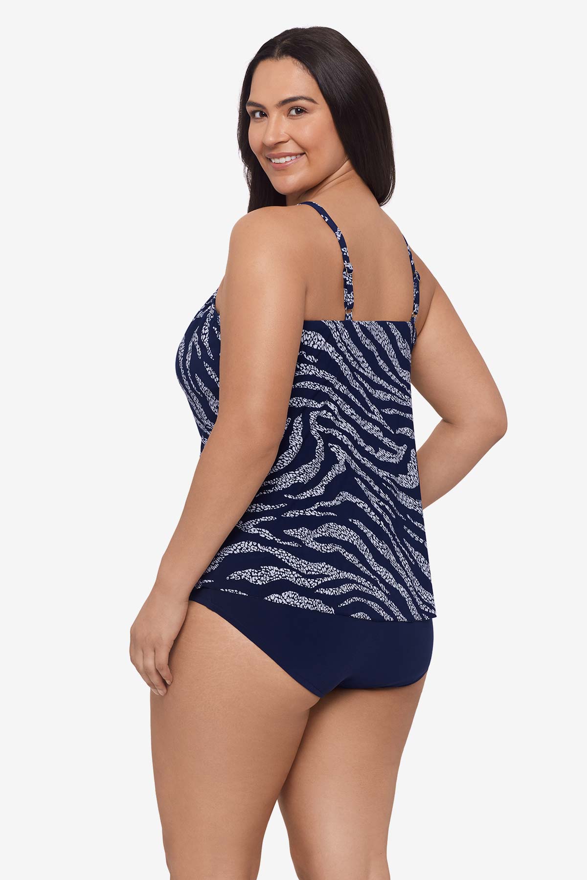 Woman faced left wearing an animal-esque printed tankini top
