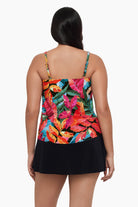 Woman turned away wearing a tankini top with a multicolored floral print