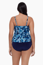 Woman turned away wearing a tankini top with a blue tie dye print