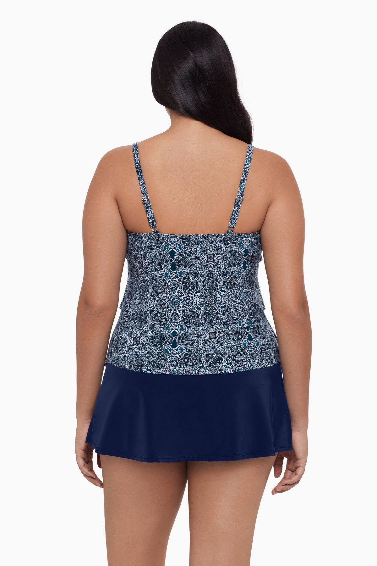 Woman turned away wearing a tankini top with a blue tile pattern