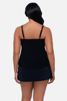 Woman turned away wearing a black  floral tankini top