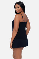 Woman turned left wearing a black floral tankini top