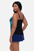 Woman turned left wearing a geometric blue printed tankini top