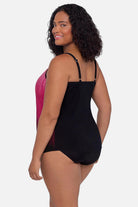 Woman turned left wearing a pink ombre tankini top
