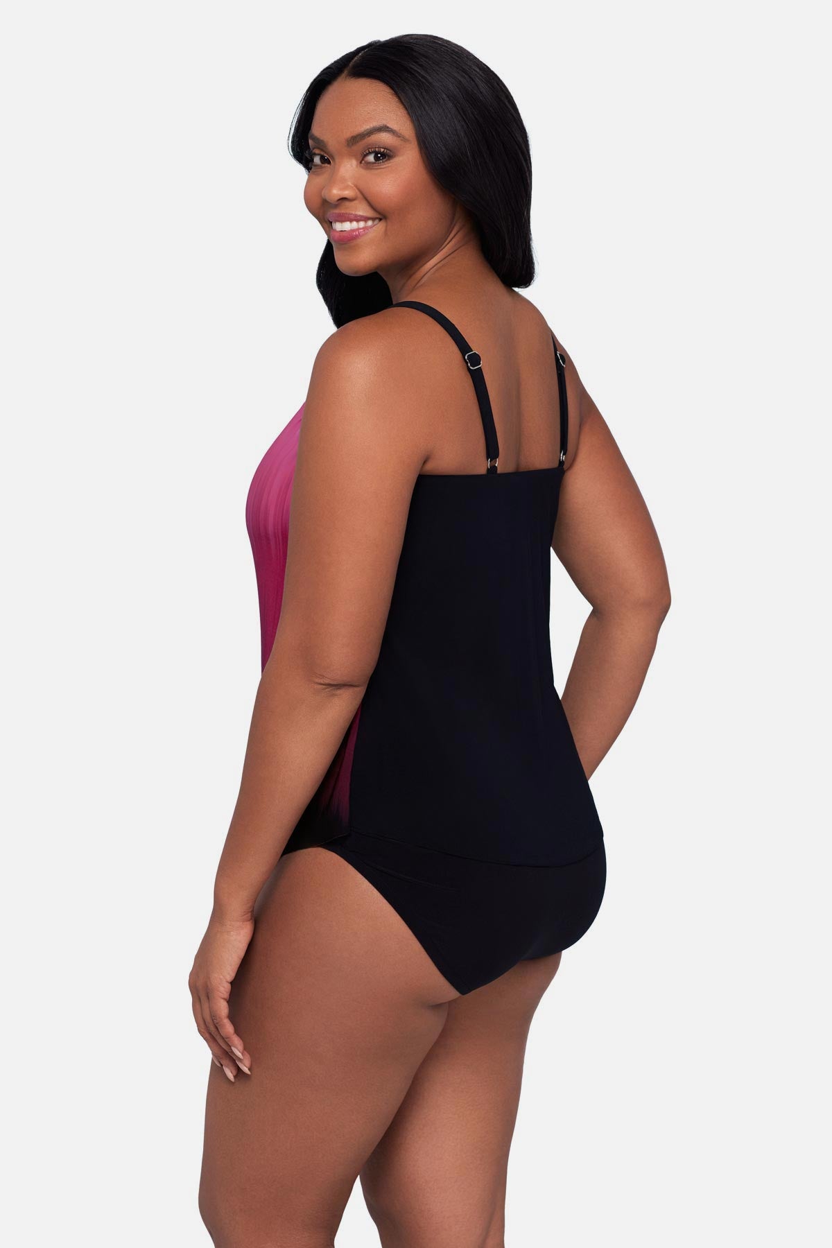 Woman turned left wearing a pink ombre tankini top