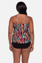 Woman turned away wearing an abstract multicolored printed tankini top