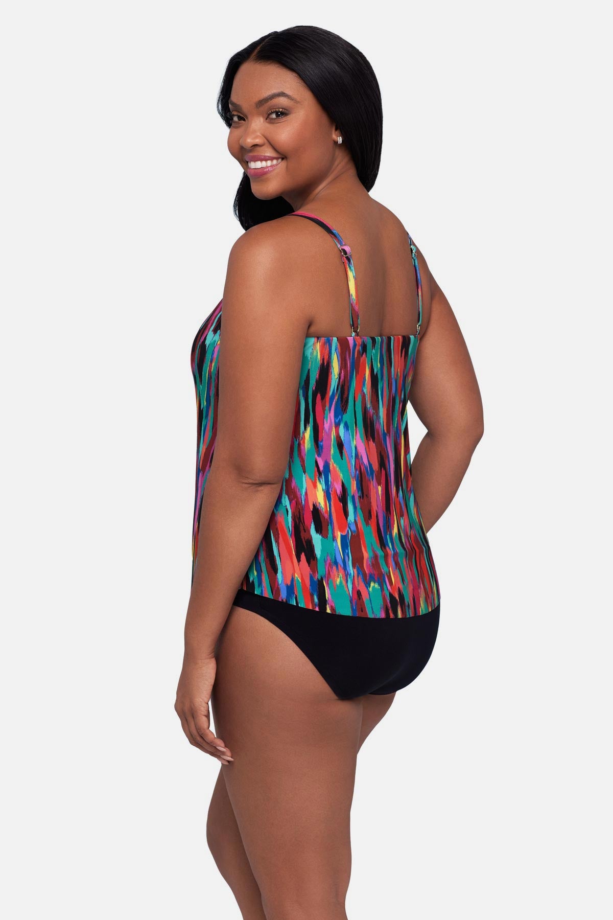 Woman turned left wearing an abstract multicolored printed tankini top