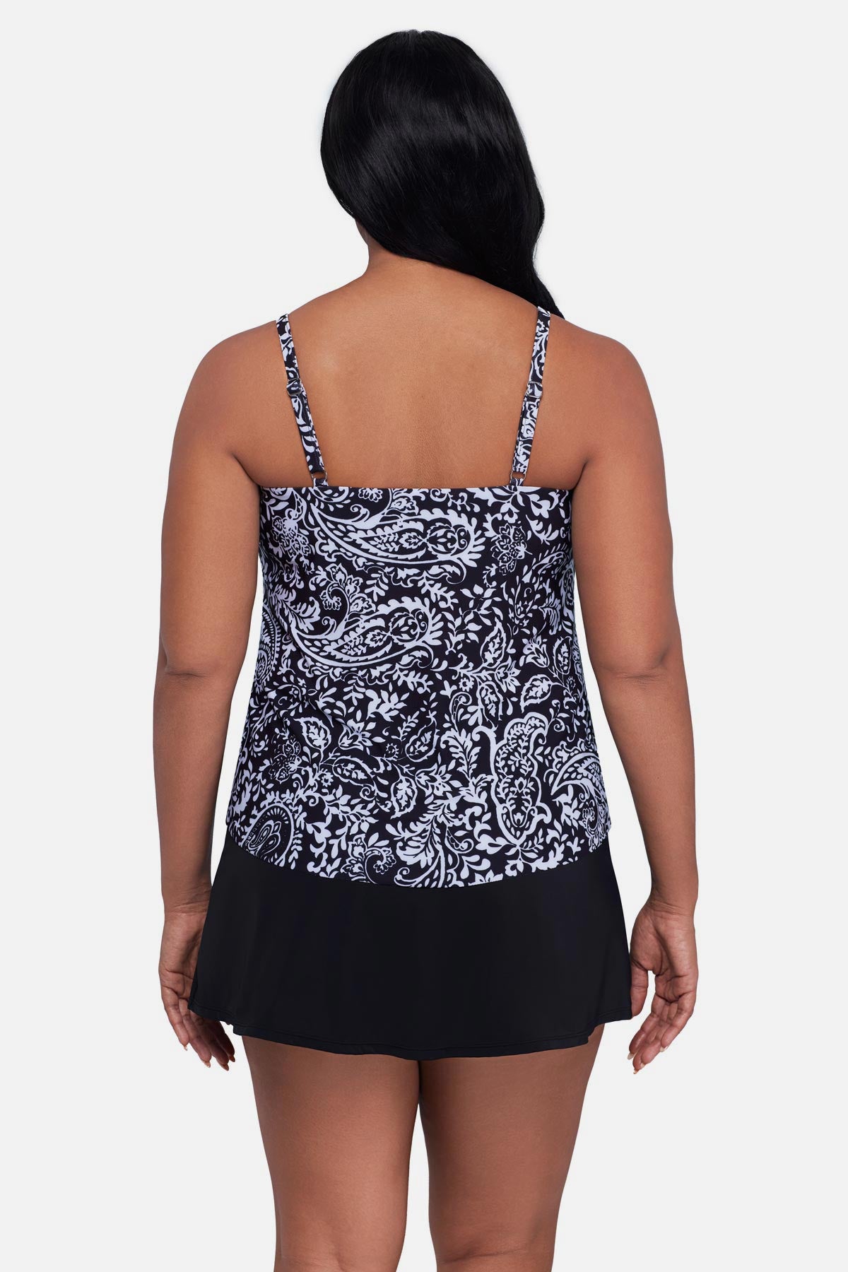 Woman turned away wearing a black and white paisley printed tankini top