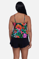 Woman turned away wearing a multicolor floral and leaf print tankini top