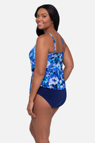 Woman turned left wearing a blue and white floral pattern tankini top