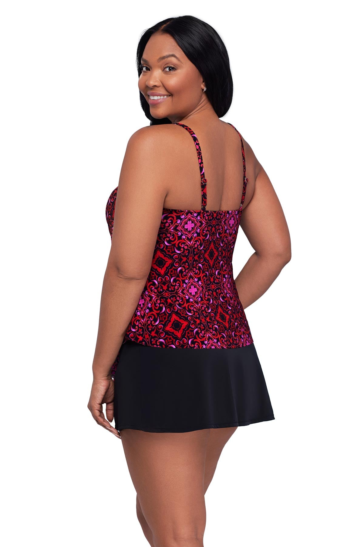 Woman turned left wearing a pink and red tile print tankini top