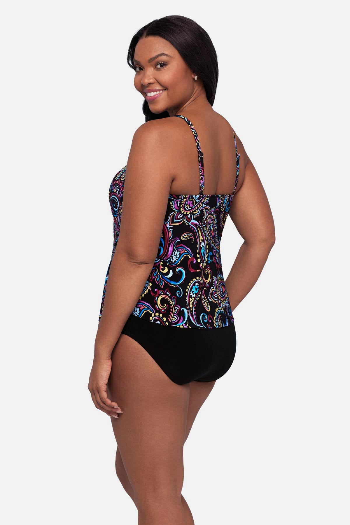 Woman turned left wearing a multicolored paisley printed tankini top with ruffles