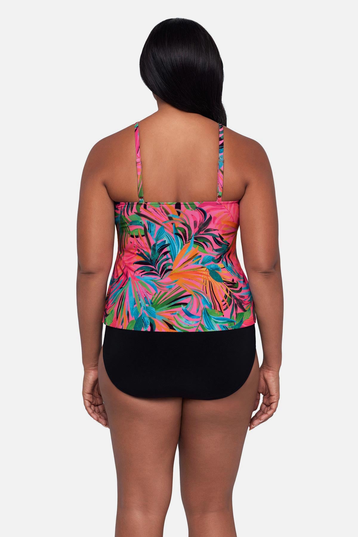Woman turned away wearing a multicolored palm leaf printed tankini top with ruffles
