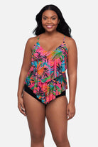 Woman wearing a multicolored palm leaf printed tankini top with ruffles