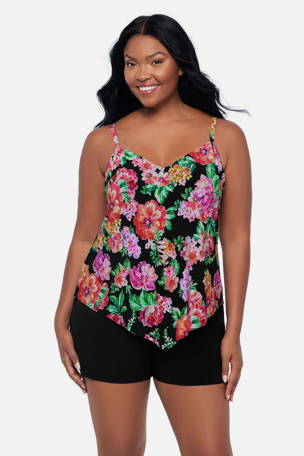 Woman wearing a pink and orange floral printed swim romper