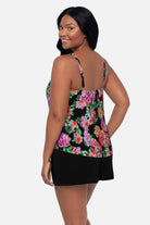 Woman turned left wearing a pink and orange floral printed swim romper