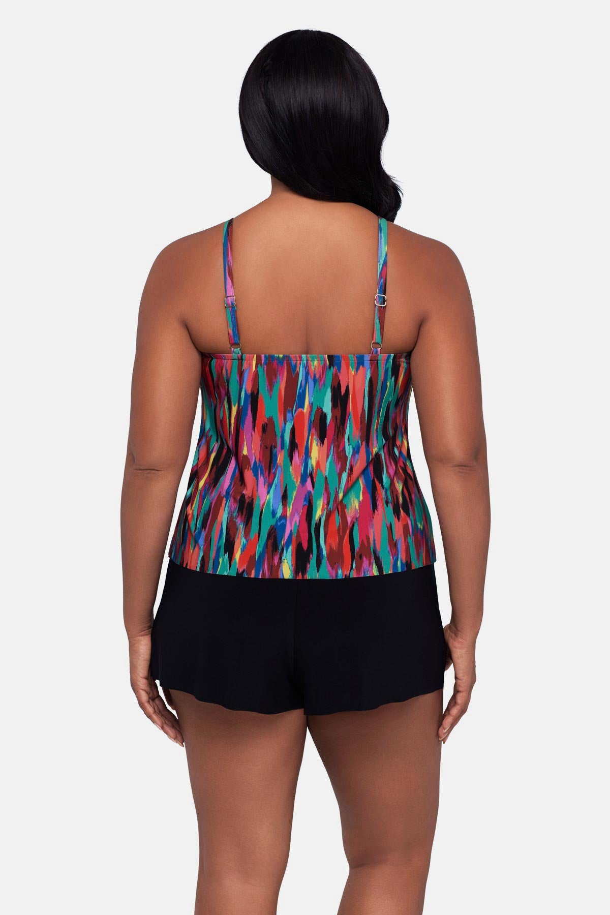 Woman turned away wearing an abstract multicolored printed swim romper