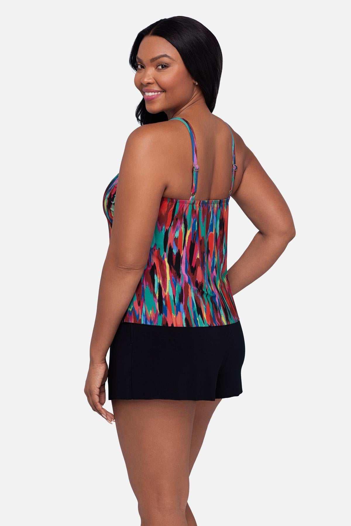 Woman turned left wearing an abstract multicolored printed swim romper
