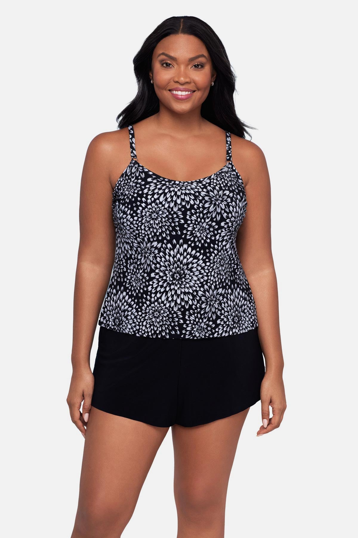 Woman wearing a black and white floral printed swim romper