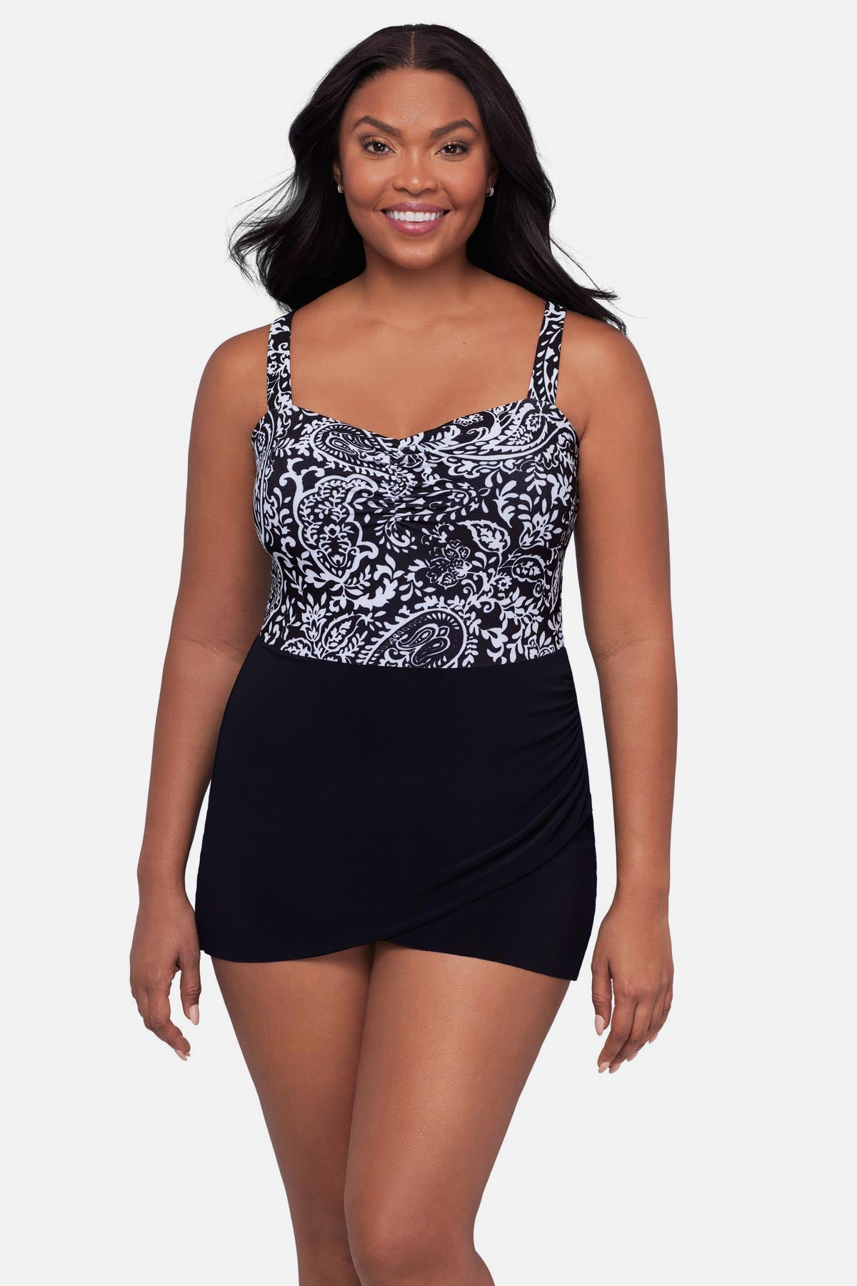 Woman wearing a black and white paisley printed swim dress