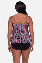 Woman turned away wearing an abstract multicolored printed tankini top with ruffles