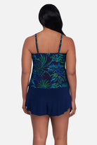 Woman turned away wearing a blue and green jungle printed tankini top with ruffles
