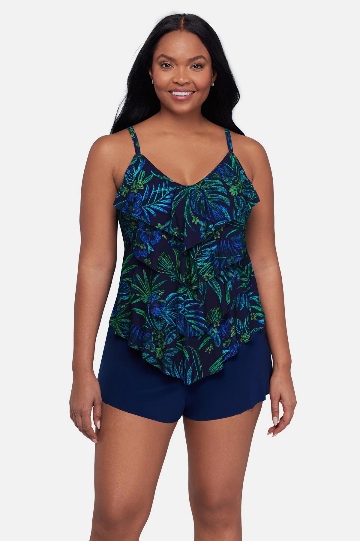 Woman wearing a blue and green jungle printed tankini top with ruffles