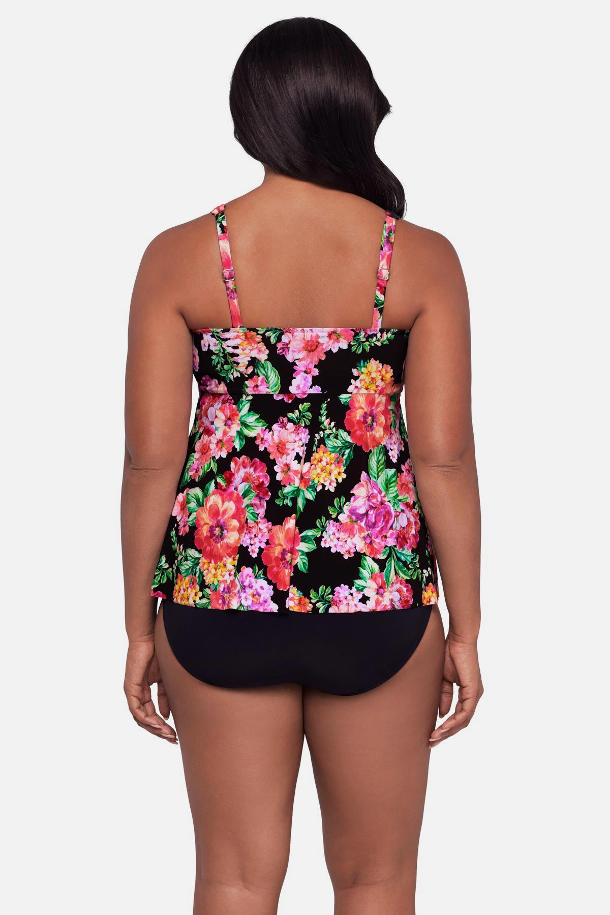 Woman turned away wearing a pink and orange floral printed tankini top