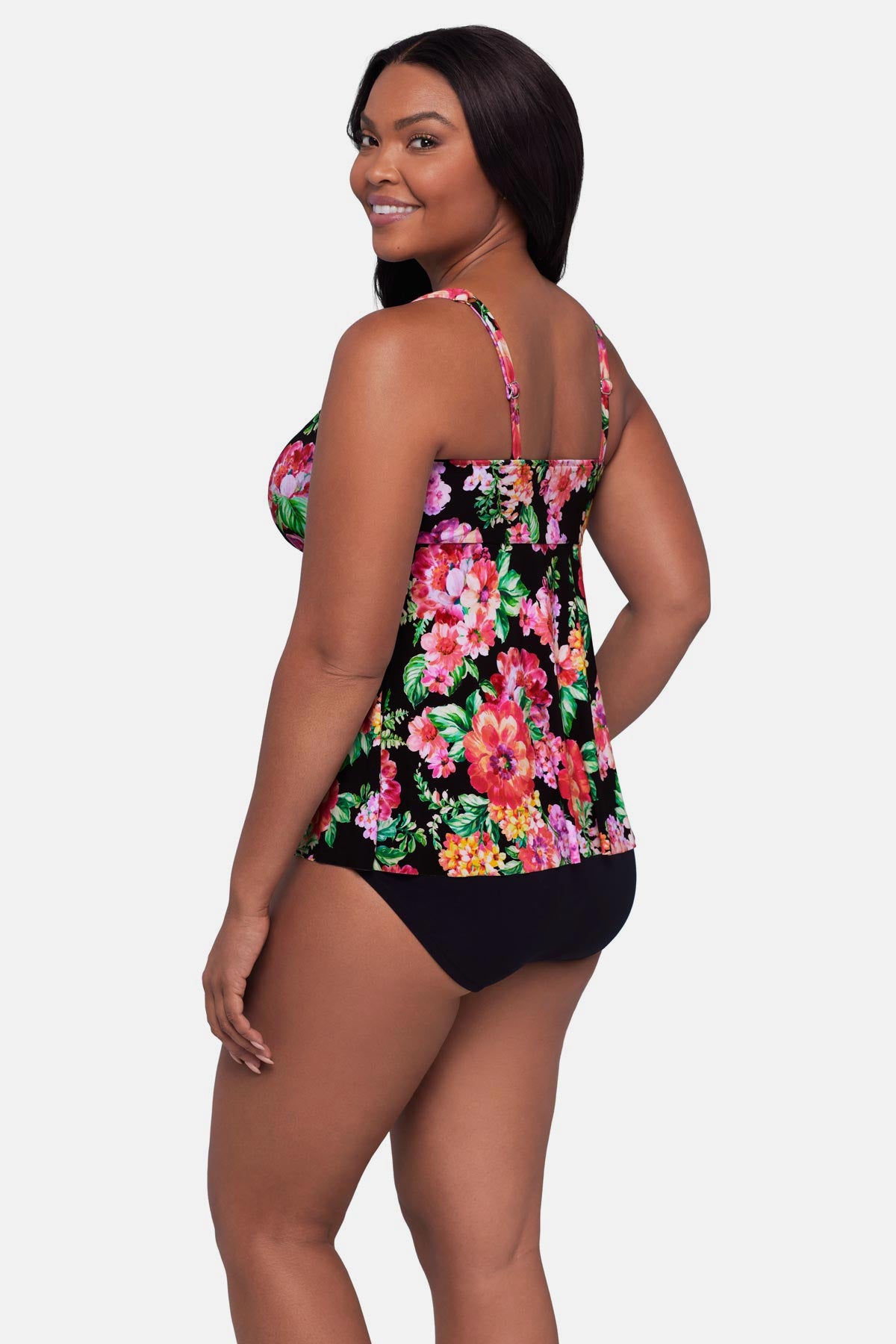Woman turned left wearing a pink and orange floral printed tankini top