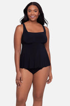 Woman wearing a black square neck tankini top