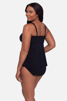Woman turned left wearing a black square neck tankini top