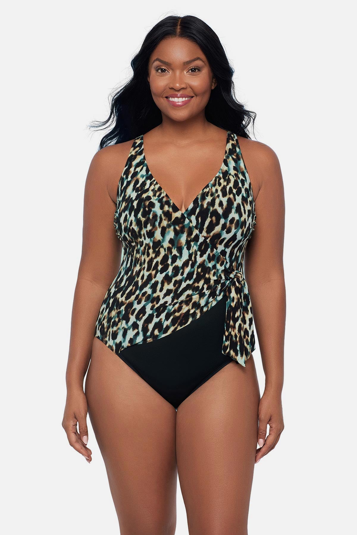 Woman wearing an animal printed one-piece swimsuit with a side tie
