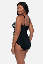 Woman turned left wearing an animal printed one-piece swimsuit with a side tie