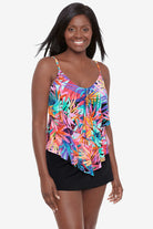 Woman wearing a multicolored palm leaf pattern ruffled tankini top