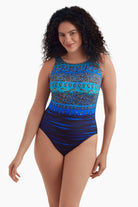 Woman wearing a blue garland printed one-piece swimsuit
