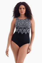 Woman wearing a black and white garland printed one-piece swimsuit