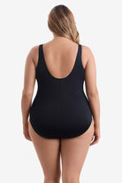 Woman wearing a black one-piece swimsuit 