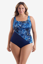 Woman wearing a blue and white abstract printed one-piece swimsuit