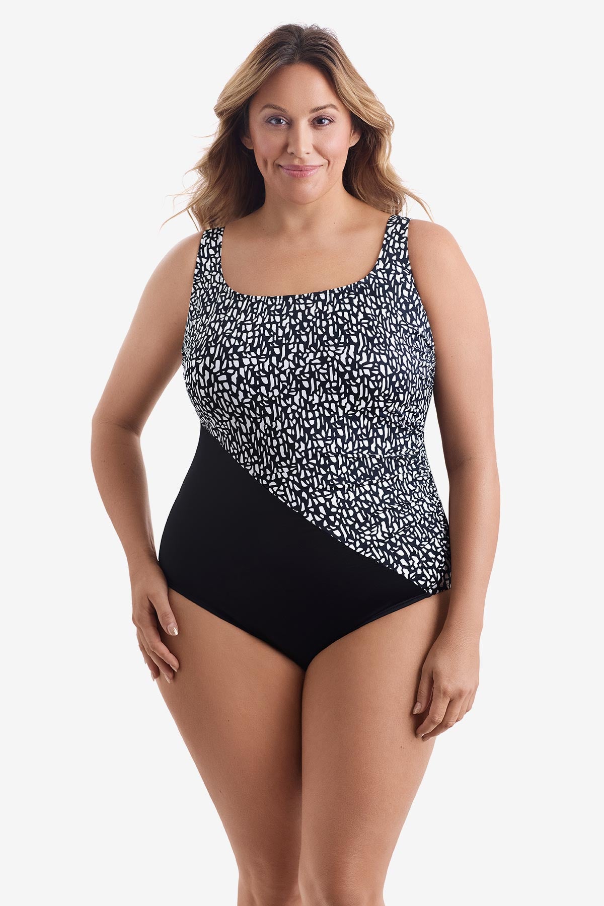 Woman wearing a black and white paper mache printed one-piece swimsuit