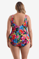 Woman turned away wearing a multicolored floral one-piece swimsuit 
