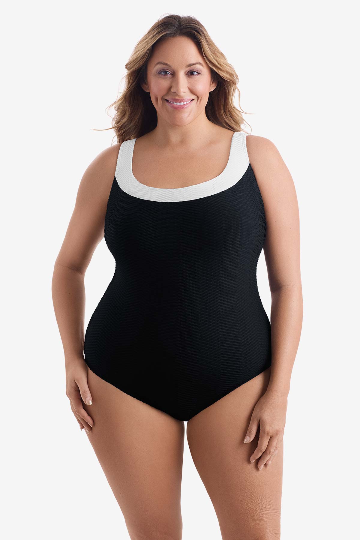 Woman wearing a black one-piece swimsuit with white trim on the neckline