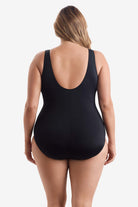 Woman wearing a black one-piece swimsuit 
