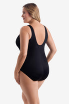 Woman wearing a black one-piece swimsuit 