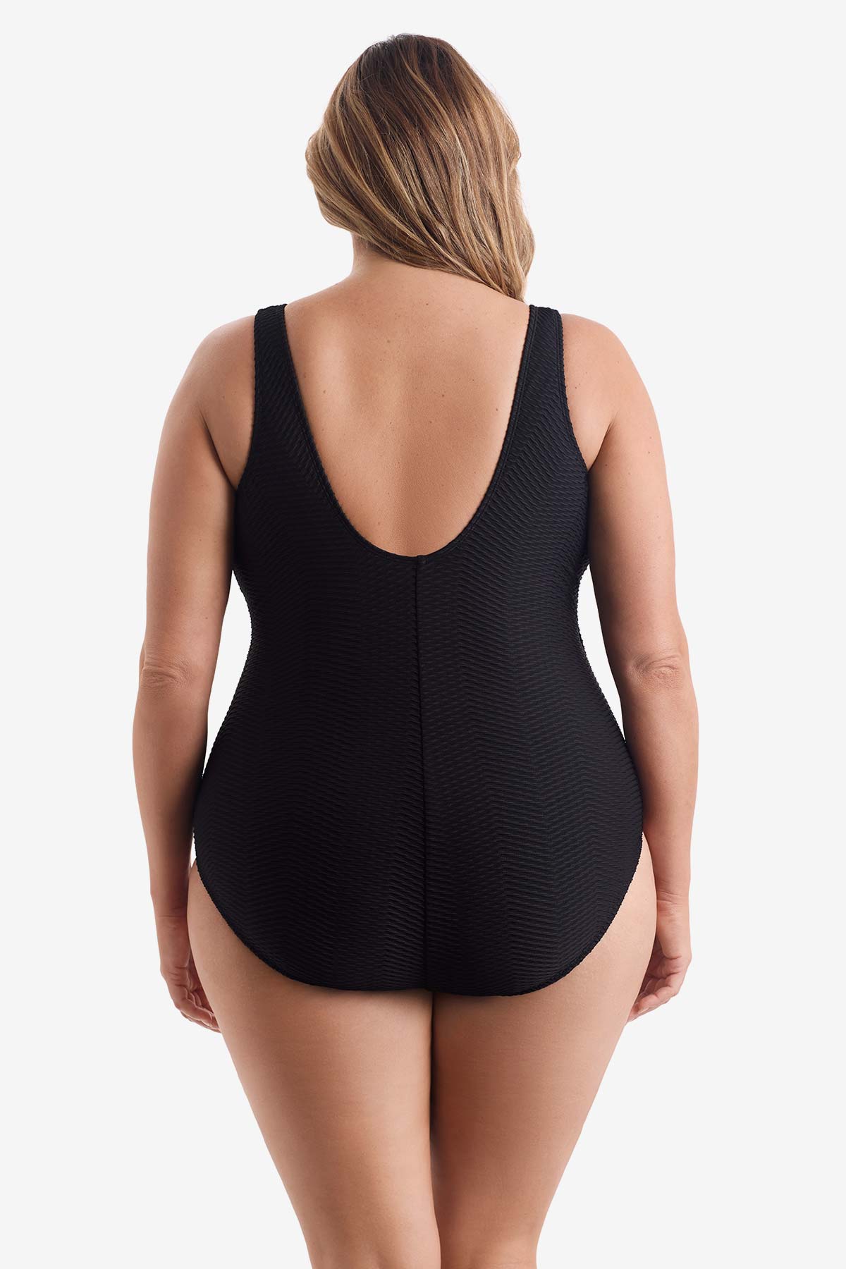 Woman faced away wearing a black one-piece swimsuit 