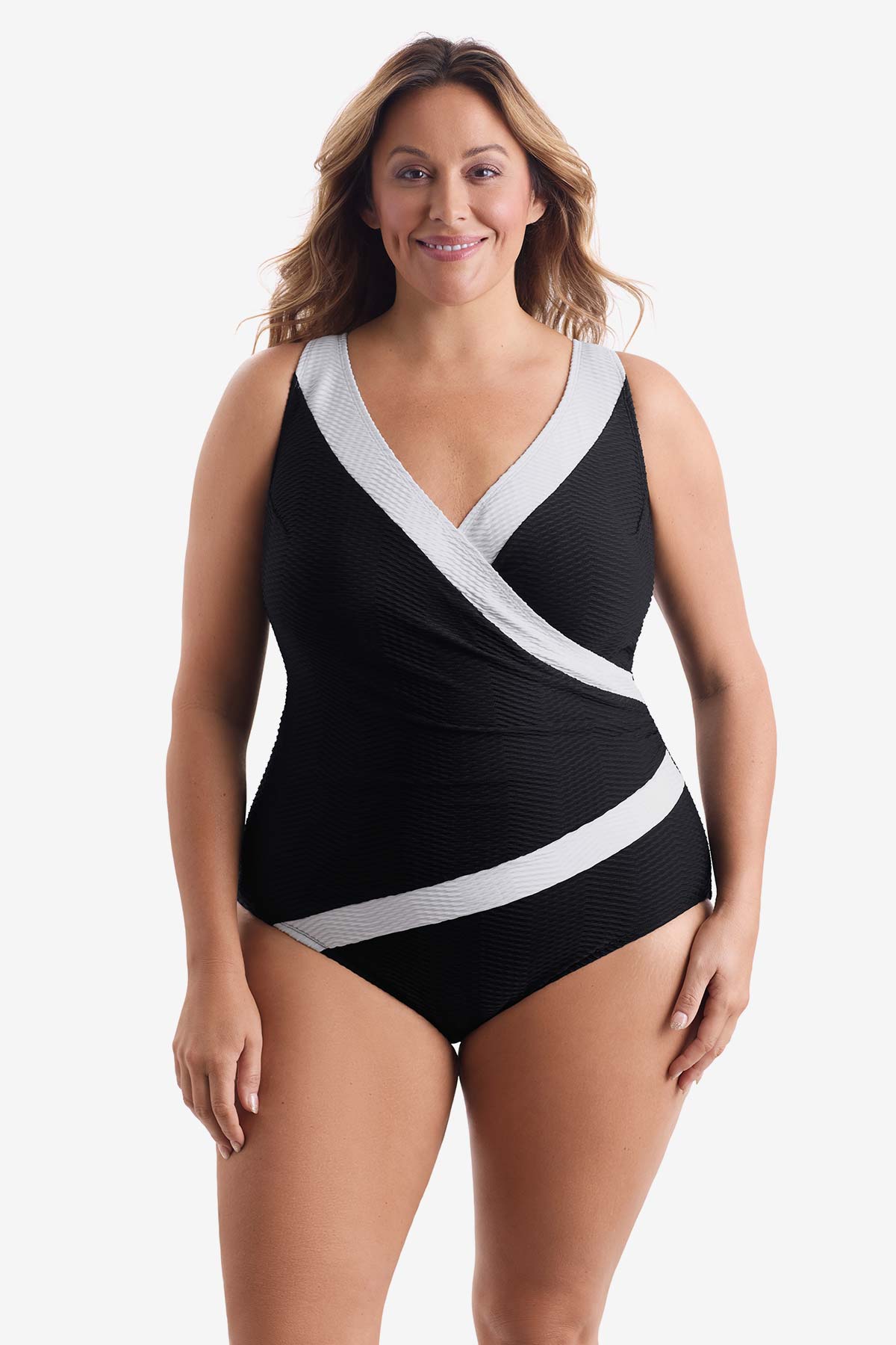 Woman wearing a black one-piece swimsuit with white lines around the suit