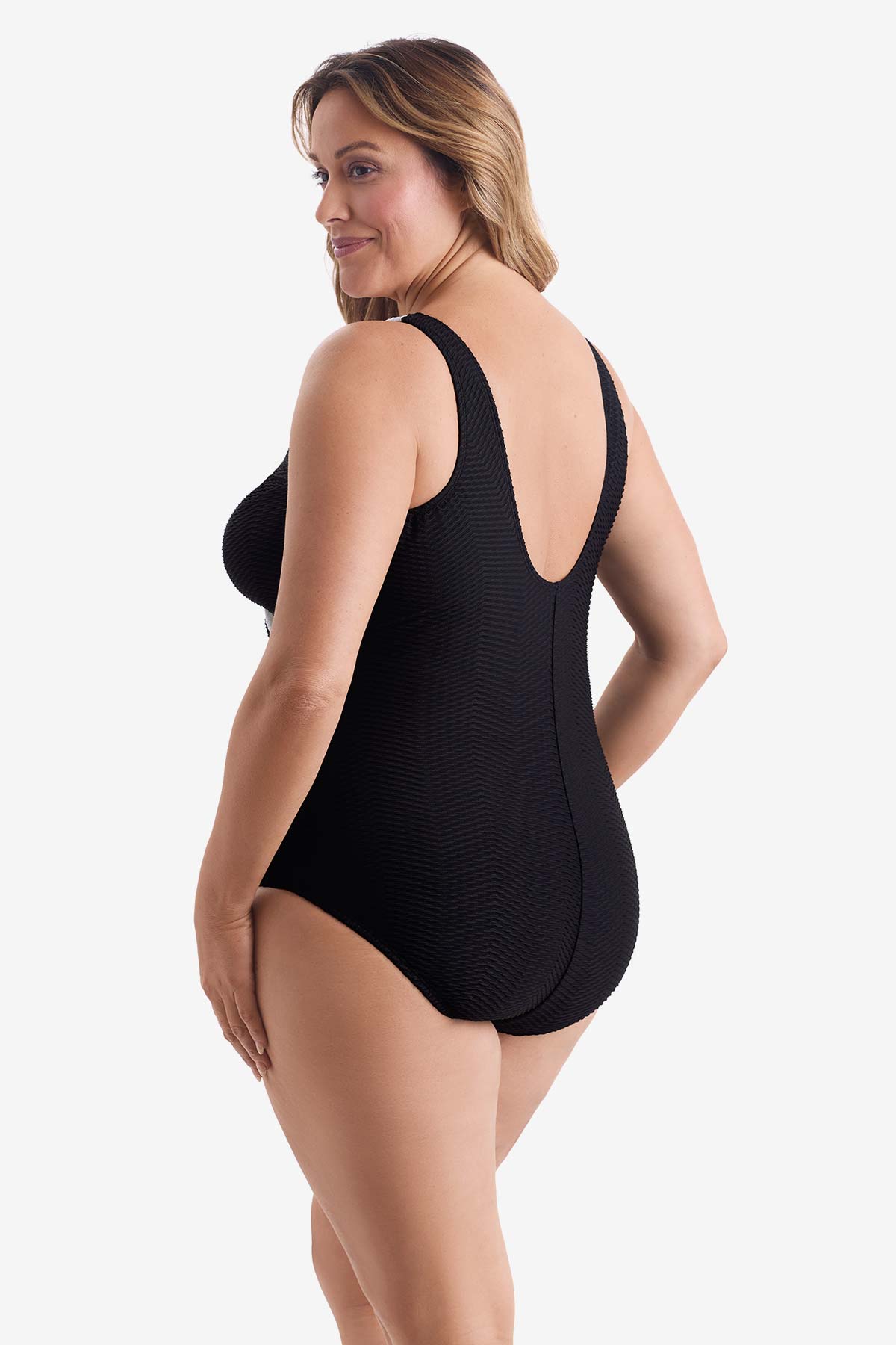 Woman faced left wearing a black one-piece swimsuit 