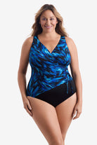 Woman wearing a black and blue feathered pattern one-piece swimsuit 