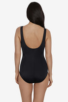 Woman turned away wearing a black and white zig zag pattern on the bust one-piece swimsuit